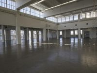 a large empty industrial building has been cleaned and stained with yellow paint and flooring