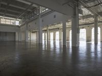 a large empty industrial building has been cleaned and stained with yellow paint and flooring