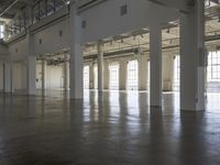 a large empty industrial building has been cleaned and stained with yellow paint and flooring