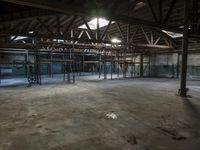 an empty room that is very big and full of concrete, with scaffolding