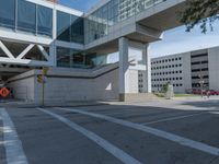 an empty intersection at a street corner next to a large building with several windows on it