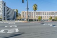 an empty intersection with a hotel on top of the building on the left and another one on the right