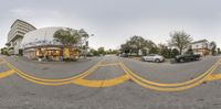 a 360 - vision image of an intersection of two roads in a city area that appears to be empty