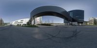 an empty intersection in the city with a large arch at the end of it's middle lane