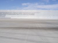 a lone jet is sitting in the middle of an empty lot of space for spectators to walk up to