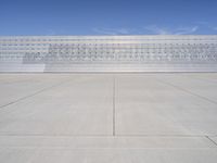 a lone jet is sitting in the middle of an empty lot of space for spectators to walk up to