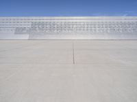 a lone jet is sitting in the middle of an empty lot of space for spectators to walk up to