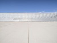 a lone jet is sitting in the middle of an empty lot of space for spectators to walk up to
