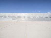 a lone jet is sitting in the middle of an empty lot of space for spectators to walk up to