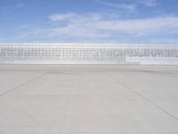 a lone jet is sitting in the middle of an empty lot of space for spectators to walk up to