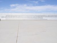 a lone jet is sitting in the middle of an empty lot of space for spectators to walk up to