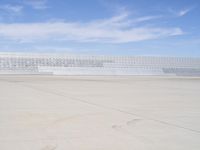 a lone jet is sitting in the middle of an empty lot of space for spectators to walk up to