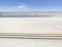 a lone jet is sitting in the middle of an empty lot of space for spectators to walk up to