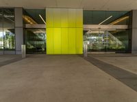 an empty lobby with two doors that open and large windows and glass on each side