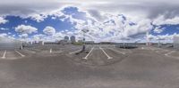 a view of an empty lot with several clouds in the sky with no one standing