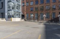 empty lot with parking meter in foreground next to a building surrounded by large windows