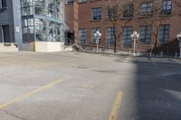 empty lot with parking meter in foreground next to a building surrounded by large windows