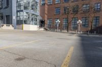 empty lot with parking meter in foreground next to a building surrounded by large windows