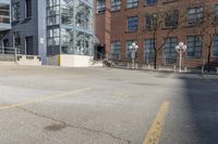 empty lot with parking meter in foreground next to a building surrounded by large windows