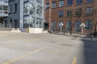 empty lot with parking meter in foreground next to a building surrounded by large windows