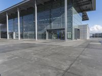 a picture of an outside building that is empty, with two levels visible and a lot of windows behind it