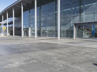 a picture of an outside building that is empty, with two levels visible and a lot of windows behind it
