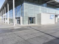 a picture of an outside building that is empty, with two levels visible and a lot of windows behind it