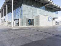 a picture of an outside building that is empty, with two levels visible and a lot of windows behind it