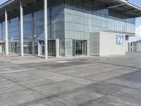 a picture of an outside building that is empty, with two levels visible and a lot of windows behind it