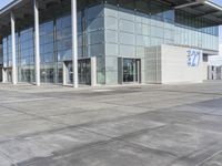 a picture of an outside building that is empty, with two levels visible and a lot of windows behind it