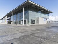 a picture of an outside building that is empty, with two levels visible and a lot of windows behind it