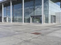 a picture of an outside building that is empty, with two levels visible and a lot of windows behind it