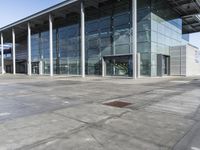 a picture of an outside building that is empty, with two levels visible and a lot of windows behind it