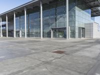 a picture of an outside building that is empty, with two levels visible and a lot of windows behind it