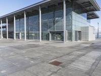 a picture of an outside building that is empty, with two levels visible and a lot of windows behind it