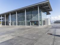 a picture of an outside building that is empty, with two levels visible and a lot of windows behind it
