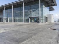 a picture of an outside building that is empty, with two levels visible and a lot of windows behind it