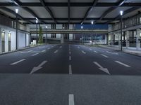 a street with empty lanes and lights is shown at night with no people around it