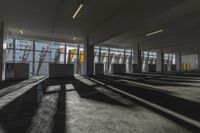 an empty office room with windows letting in sunlight and shadows all around it and on the floor