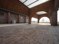 an empty brick walled courtyard has been opened up into the outdoors area of the building