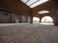 an empty brick walled courtyard has been opened up into the outdoors area of the building