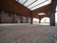 an empty brick walled courtyard has been opened up into the outdoors area of the building