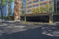 an empty parking area in front of a multistory building surrounded by apartment buildings