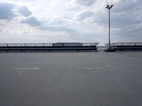 a boat is parked in an empty parking lot near an air port on the water