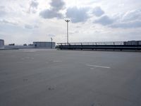 a boat is parked in an empty parking lot near an air port on the water