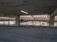 an empty parking lot with no vehicles in it while two people wait to leave the building