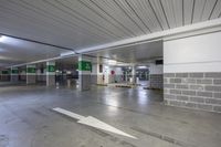 the parking garage is empty of people, with arrow drawn on it and signs for each one