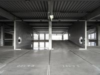 a large empty parking garage with several seats and an area for bicycles to sit on