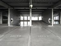 a large empty parking garage with several seats and an area for bicycles to sit on