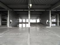 a large empty parking garage with several seats and an area for bicycles to sit on